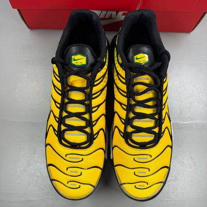 Nike Air Max Plus trainers yellow with pine green accents and logo detail.