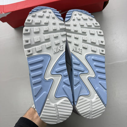 Nike Air Max 90 white trainers with light smoke grey and blue accents, logo on tongue.