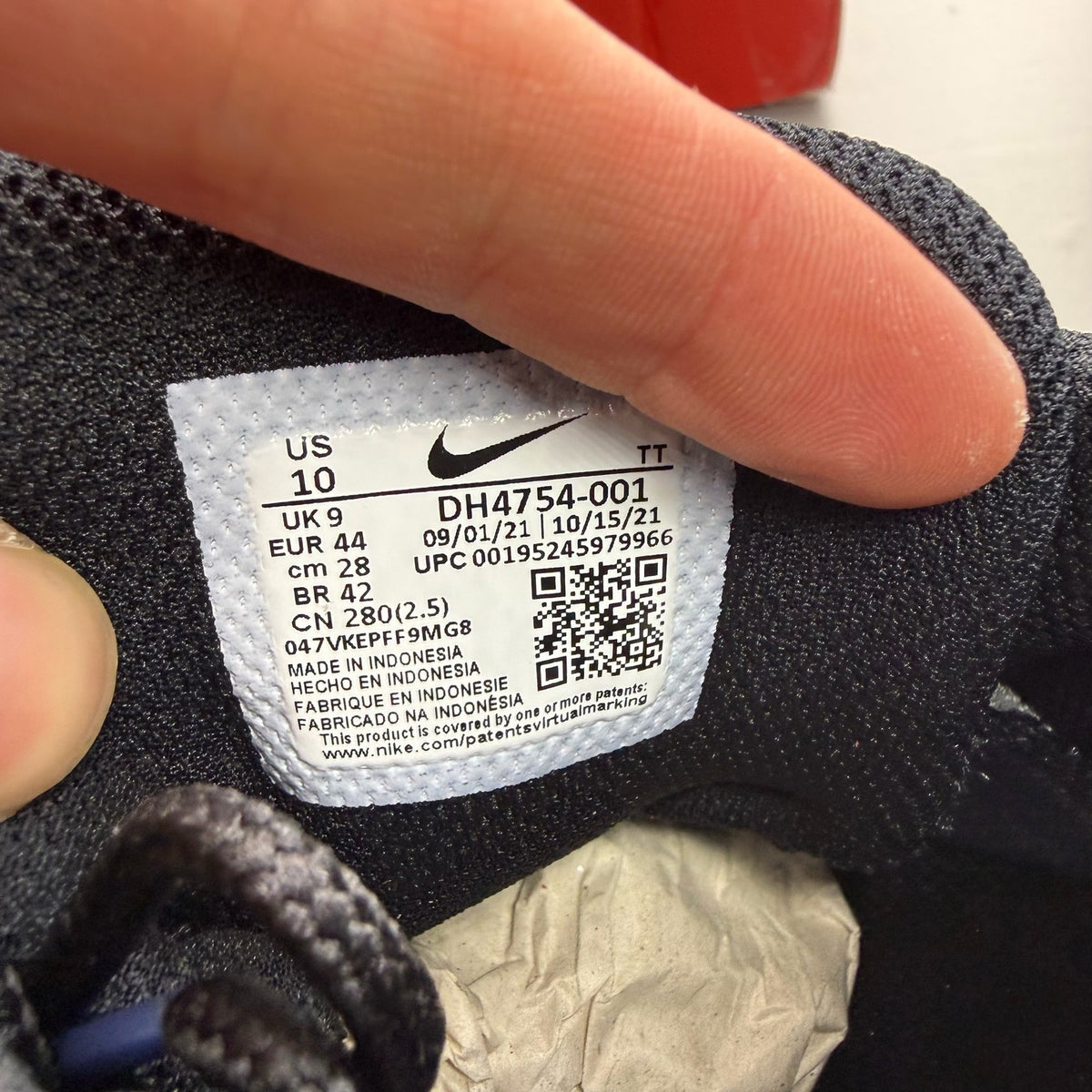 Nike black trainers with grey and white accents, featuring Air Max cushioning and logo.