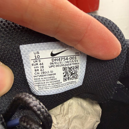 Nike black trainers with grey and white accents, featuring Air Max cushioning and logo.