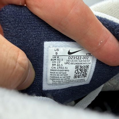 Nike Air Max 90 white trainers with obsidian and pewter accents, featuring logo detail.