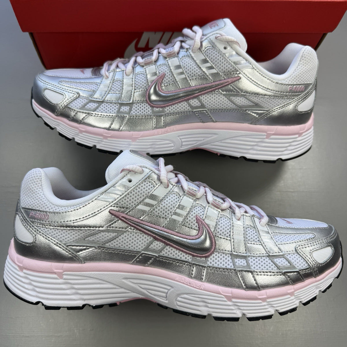 Nike P-6000 white trainers with elemental pink and silver accents, featuring logo details.