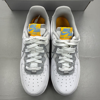Nike Air Force 1 React white trainers with smoke grey accents and logo details.