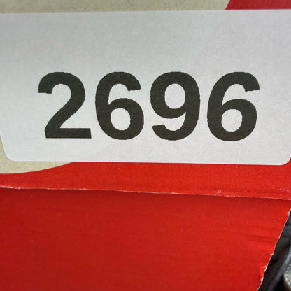 Nike black Air Huarache trainers with safety orange accents and white sole.