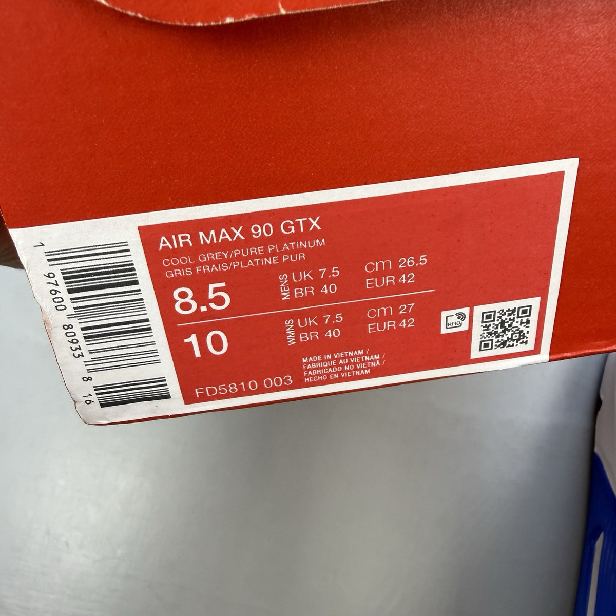 Nike Air Max 90 trainers cool grey with blue accents and Gore-Tex material.