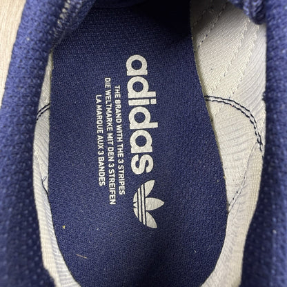 Adidas blue LA Trainers with white stripes and logo detailing on the side.