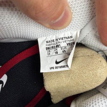 Nike deck shoes white leather with red accents and logo detail.