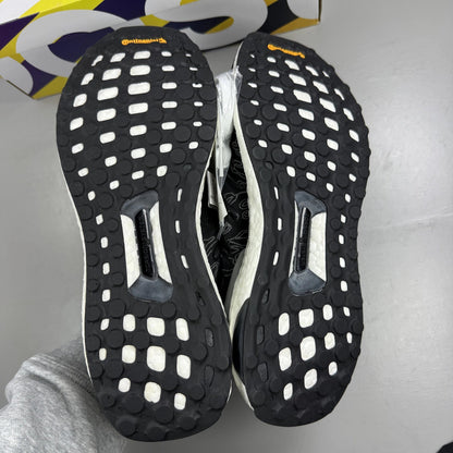 Adidas Ultra Boost black trainers with Undefeated logo and breathable mesh upper.