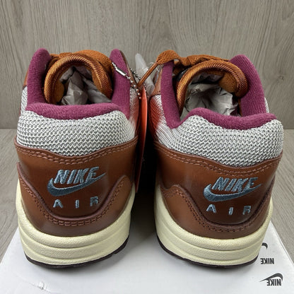 Nike Air Max 1 brown trainers with unique Patta logo and premium suede material.