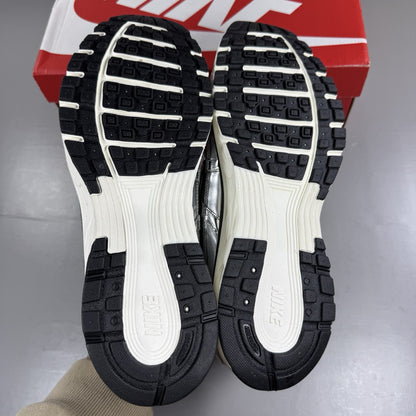 Nike P-6000 metallic silver trainers with black accents and white detailing.