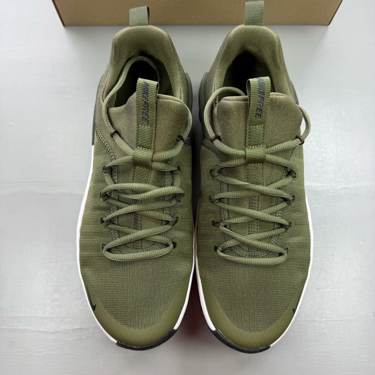 Nike green trainers with breathable mesh upper and cushioned sole.