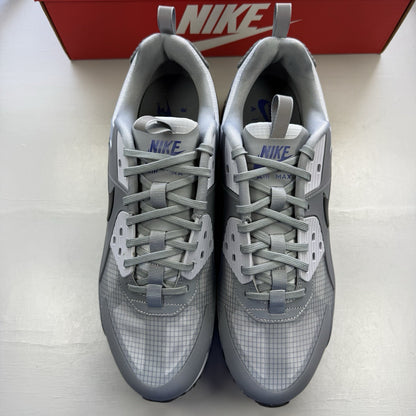 Nike Air Max 90 Drift grey trainers with deep royal blue accents and logo details.