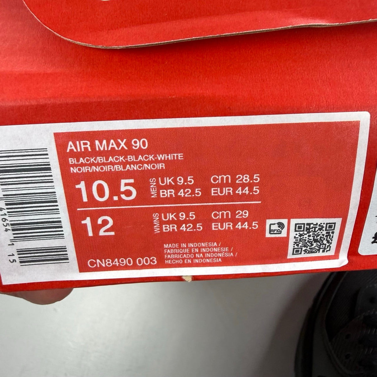 Nike black deck shoes with Air Max cushioning and sleek design.