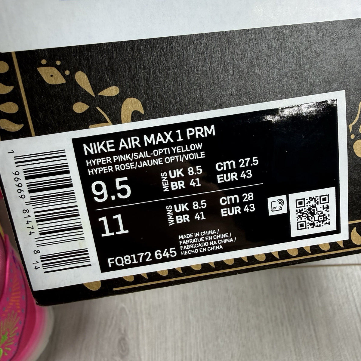 Nike Air Max 1 PRM trainers pink with Día De Muertos pattern and white accents.
