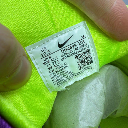 Nike white trainers with magenta neon accents and signature logo details.