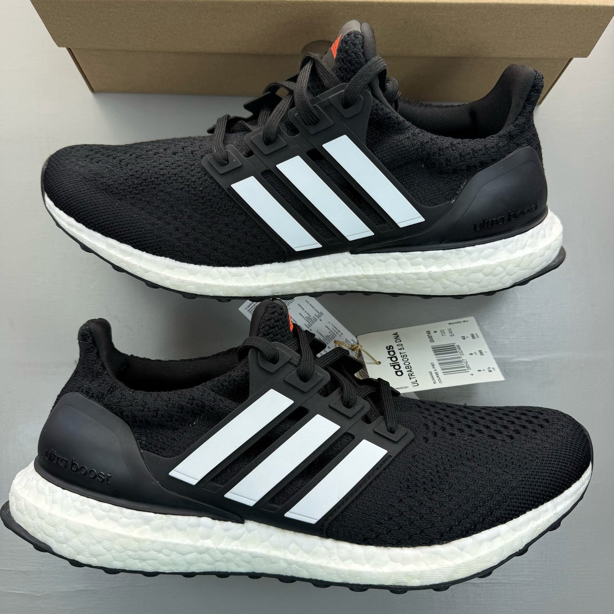Adidas black Ultra Boost 5.0 trainers with white accents and logo detailing.