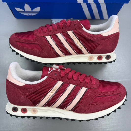 Adidas pink trainers with white stripes and logo, featuring a retro design.