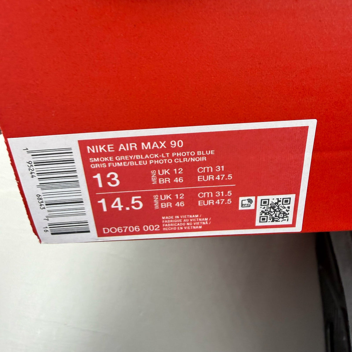 Nike Air Max 90 grey trainers with light blue accents and signature logo.