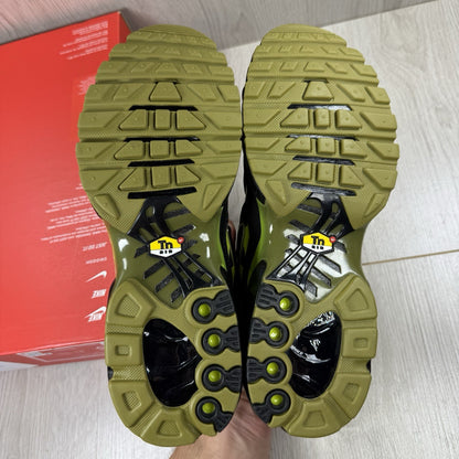 Nike Air Max Plus TN trainers black with moss green accents and signature logo.