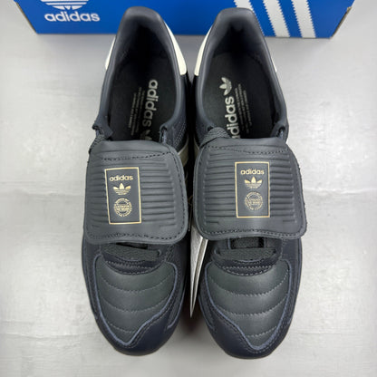 Adidas black deck shoes with blue and white accents, featuring classic logo design.
