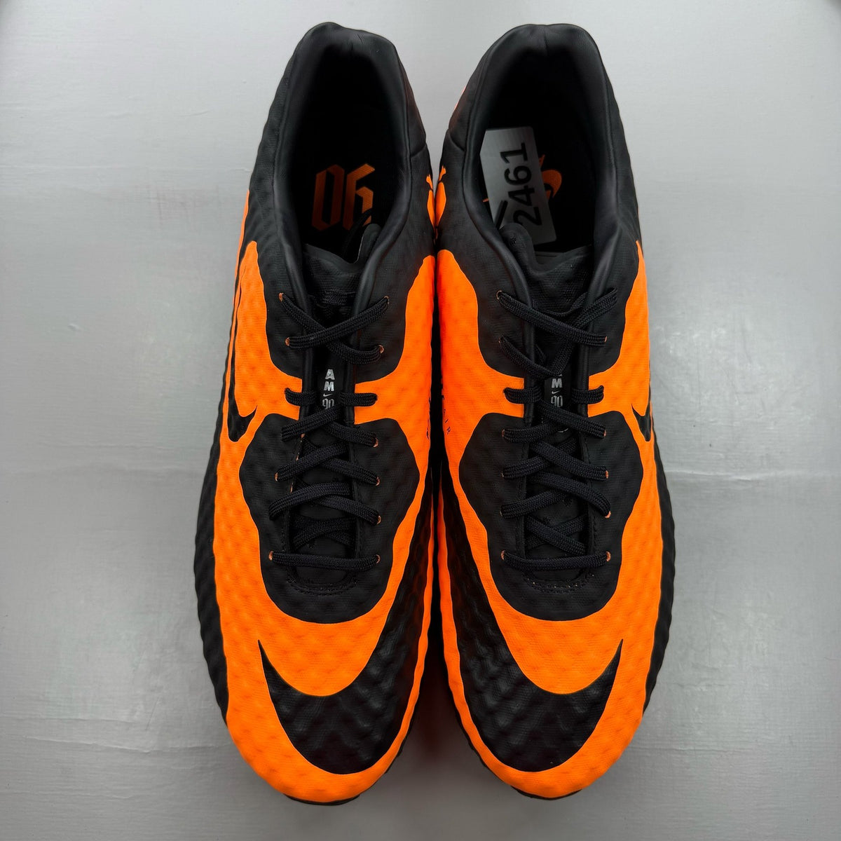 Nike black trainers with bright citrus accents and Hypervenom design details.