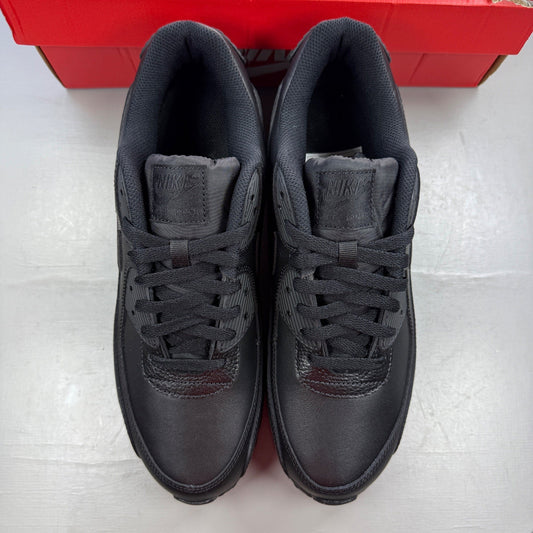 Nike Air Max 90 black leather trainers with logo detailing and textured upper.