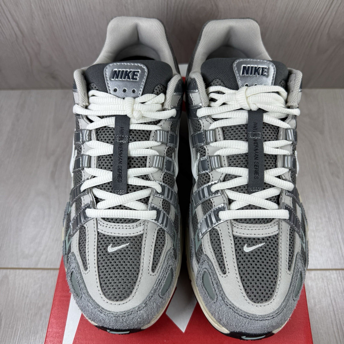 Nike grey P-6000 trainers with mesh upper and reflective detailing.