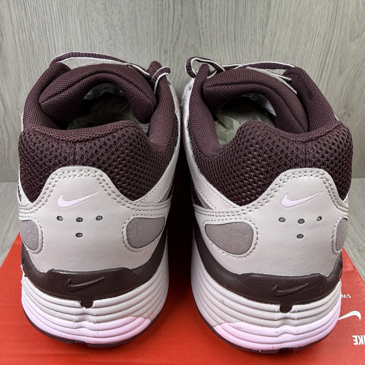 Nike P-6000 trainers purple with pink accents and mesh material detailing.