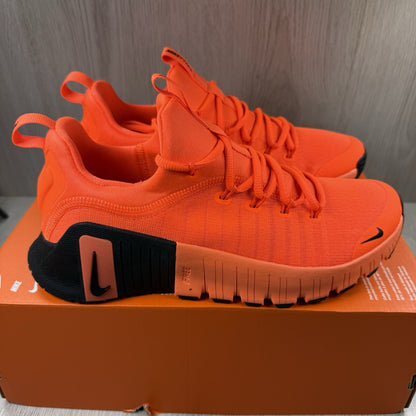Nike orange trainers with Hyper Crimson accents and breathable mesh upper.