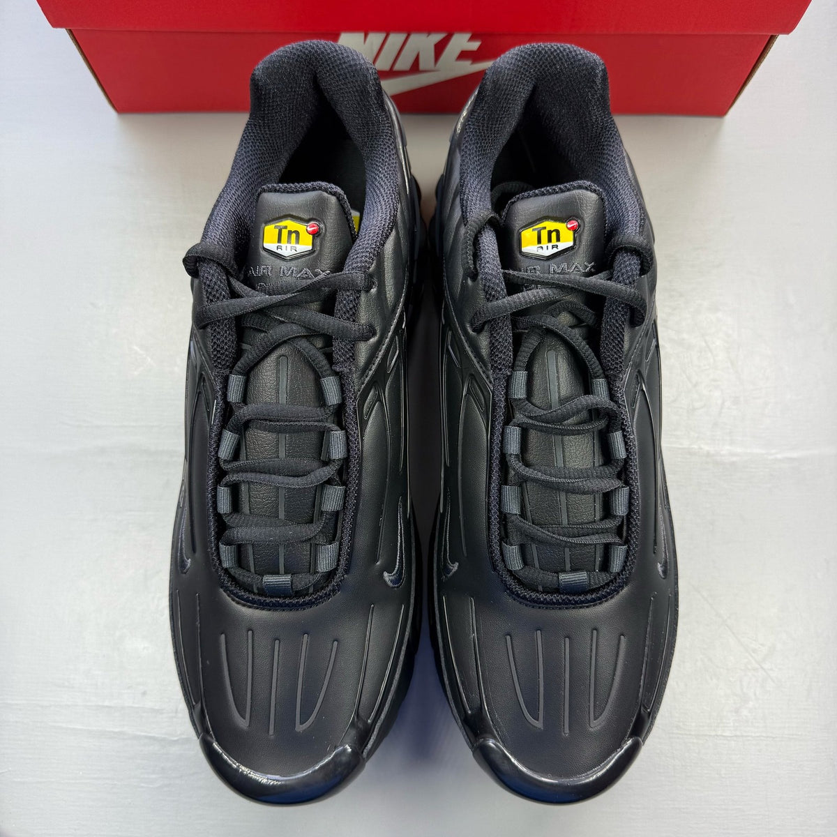Nike Air Max Plus TN 3 black leather trainers with distinctive wave pattern and logo.
