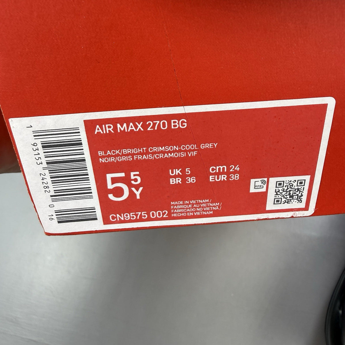 Nike Air Max 270 BG black trainers with crimson red accents and grey detailing.