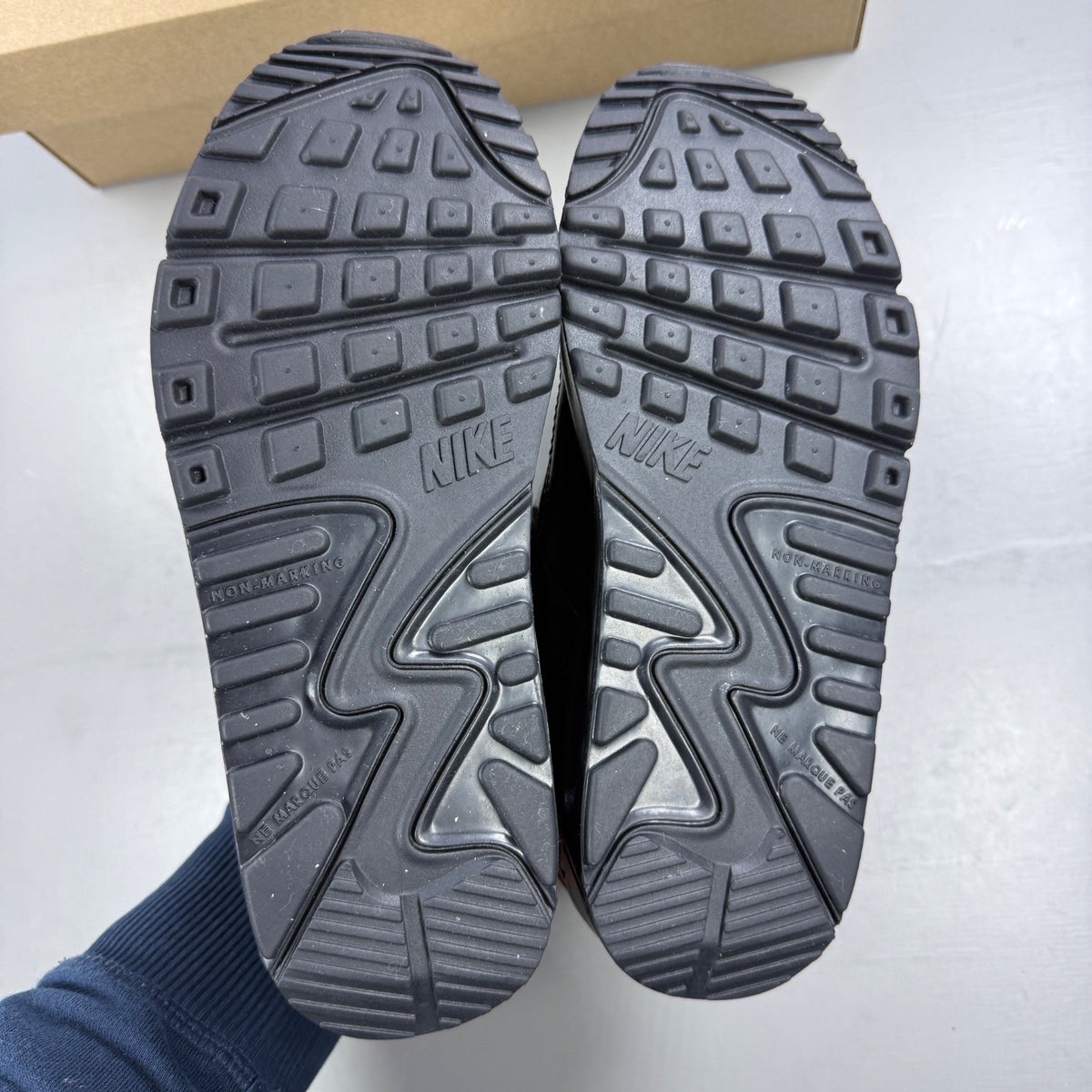 Nike black athletic shoes leather with Air Max logo and triple black design.