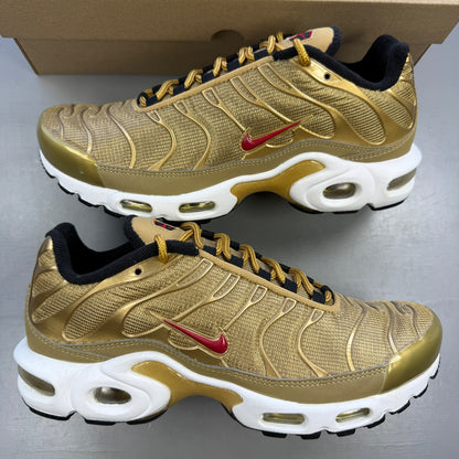 Nike gold trainers with metallic finish and distinctive Air Max Plus TN design.