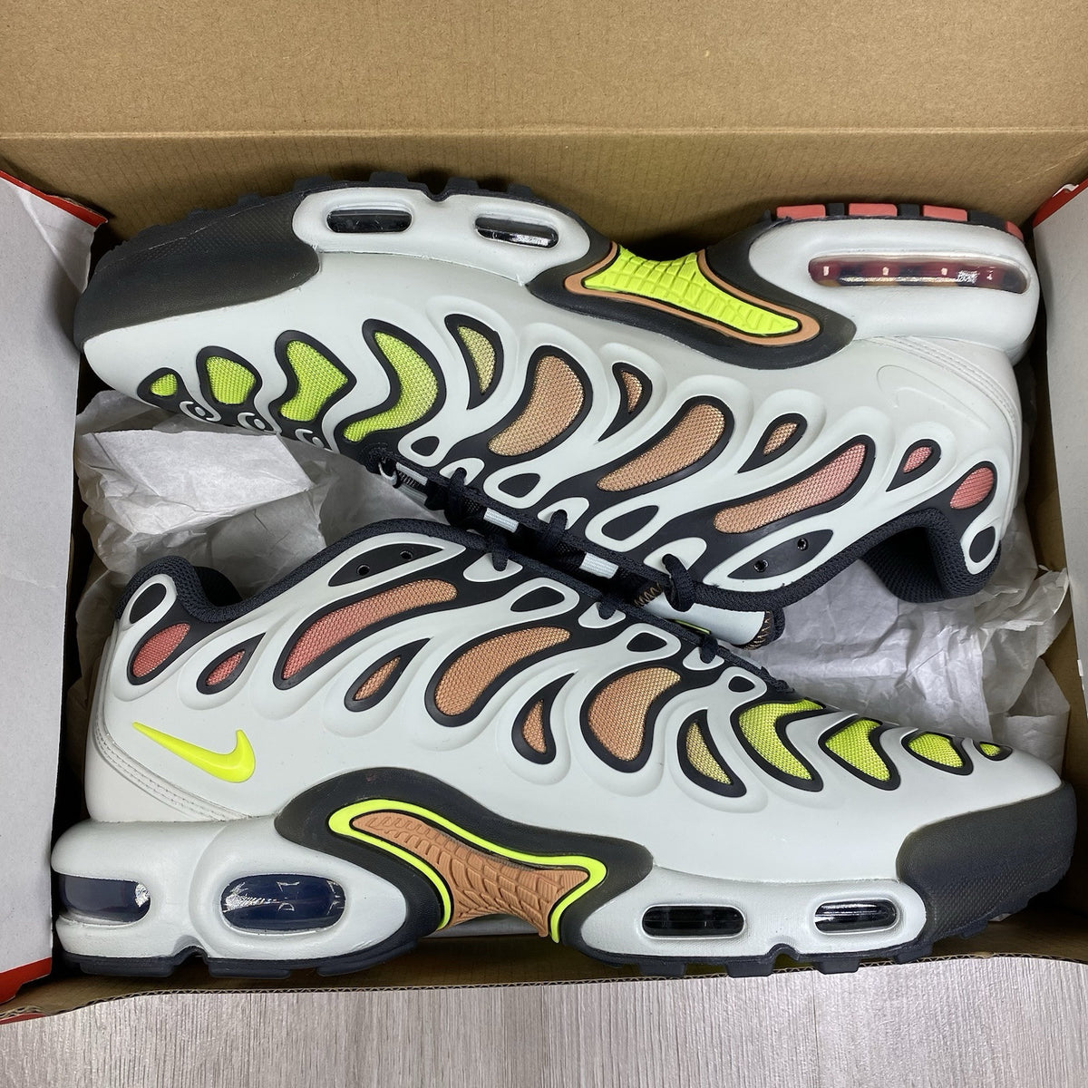 Nike Air Max Plus TN trainers silver with volt accents and signature logo details.