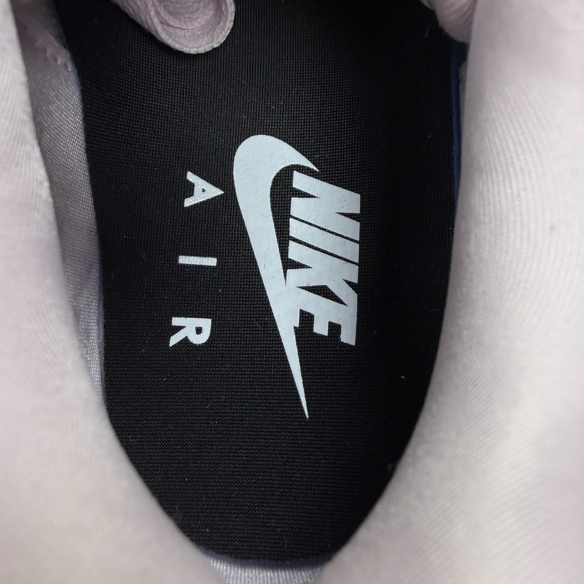 Nike Air Max 1 trainers pink with silver accents and unique design details.