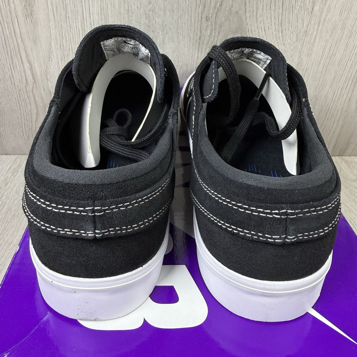Nike black SB Zoom Stefan Janoski RM sneakers with white logo and sleek design.