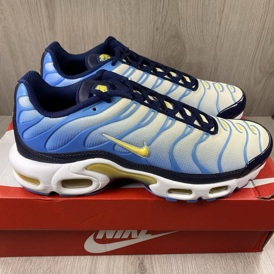 Nike Air Max Plus TN blue trainers with yellow accents and signature swoosh logo.