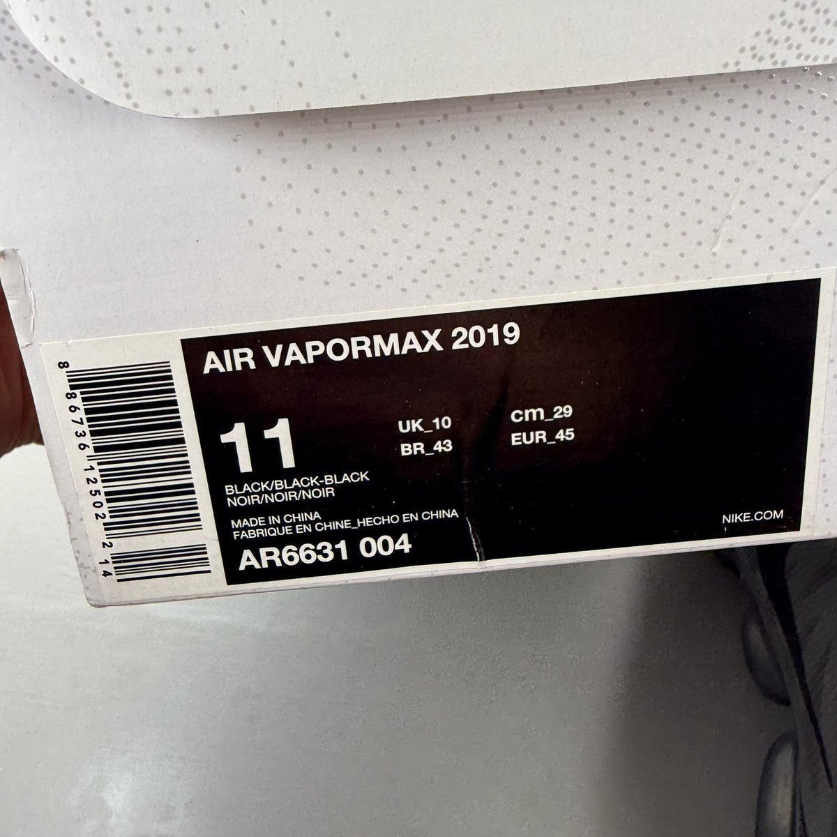 Nike Air VaporMax 2019 black trainers with distinctive air cushioning and sleek design.