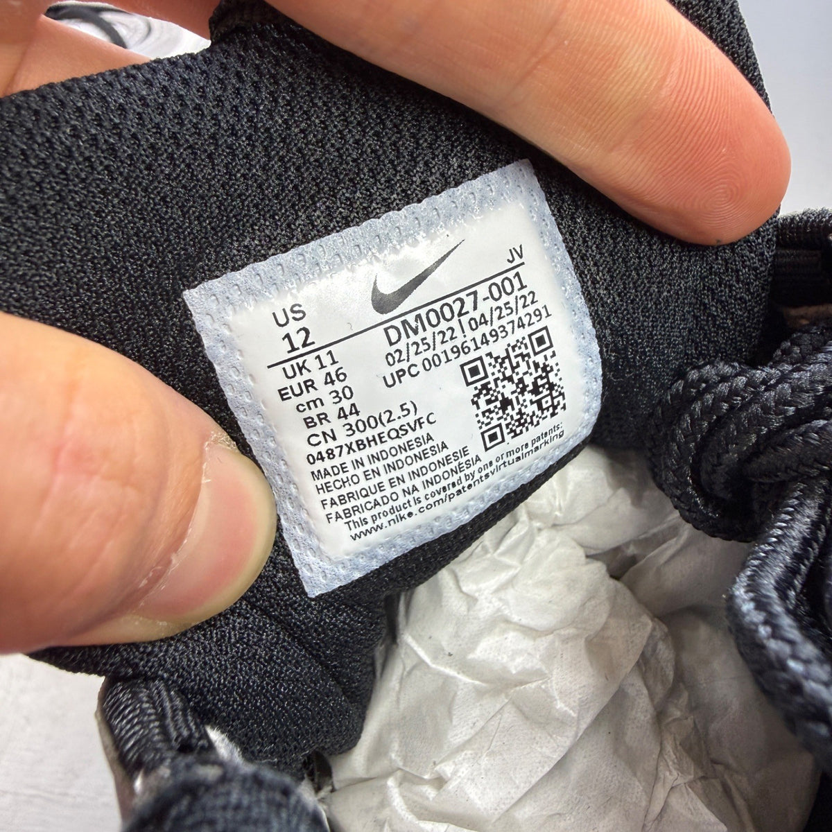 Nike black athletic shoes with metallic silver accents and signature logo detailing.