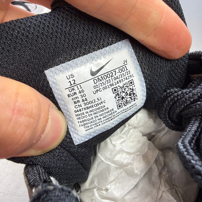 Nike black athletic shoes with metallic silver accents and signature logo detailing.
