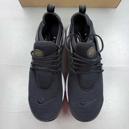Nike Air Presto black trainers with white accents and breathable mesh upper.