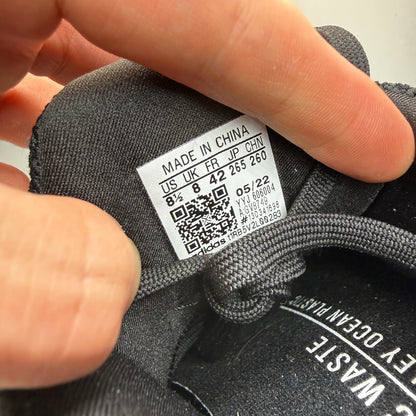 Adidas black Ultra Boost 5.0 trainers with white accents and logo detailing.