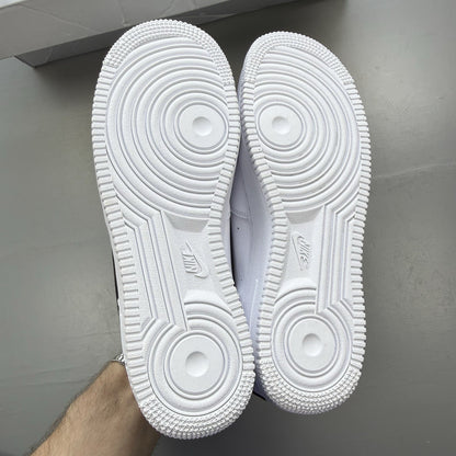 Nike Air Force 1 Low trainers white with black swoosh logo and leather upper.