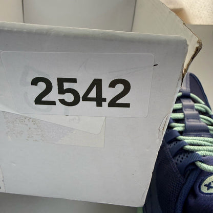 Nike Air Max 95 navy blue trainers with green accents and classic logo detailing.
