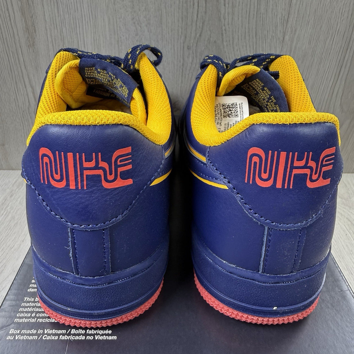 Nike blue trainers with gold accents and retro design elements.