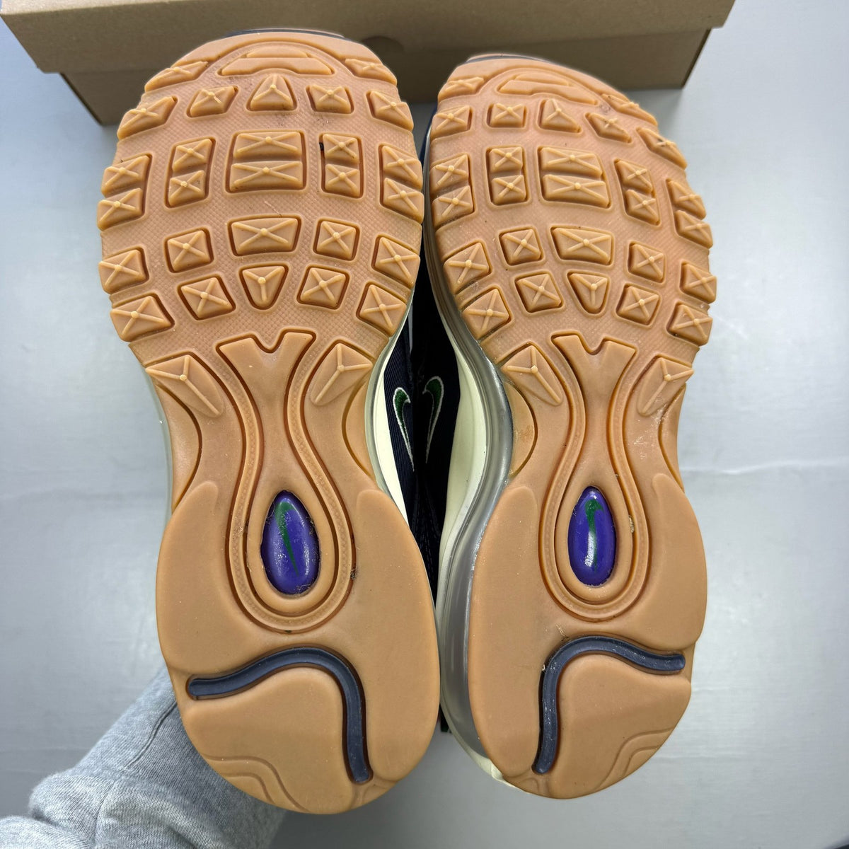 Nike Air Max 97 trainers blue with obsidian navy accents and signature swoosh logo.