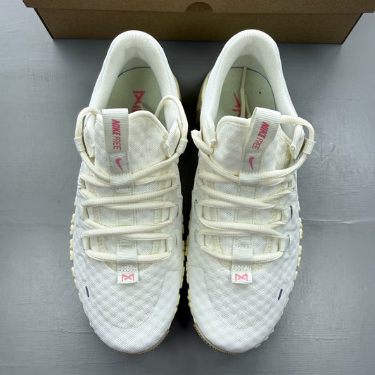 Nike white trainers with mesh upper and subtle branding details.