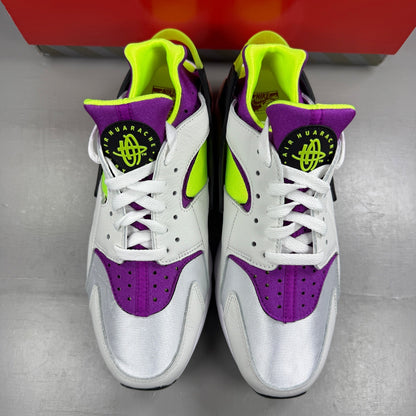 Nike white trainers with magenta neon accents and signature logo details.