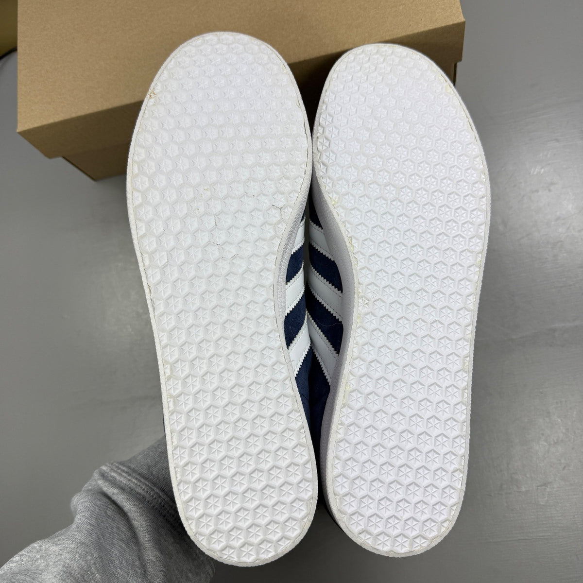 Adidas blue suede trainers with white stripes and logo detailing.