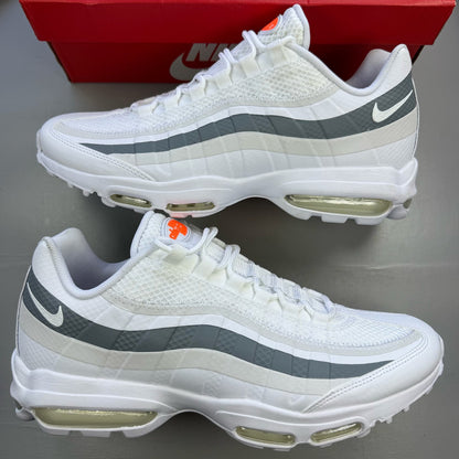 Nike Air Max 95 white trainers with grey accents and distinctive air cushioning design.